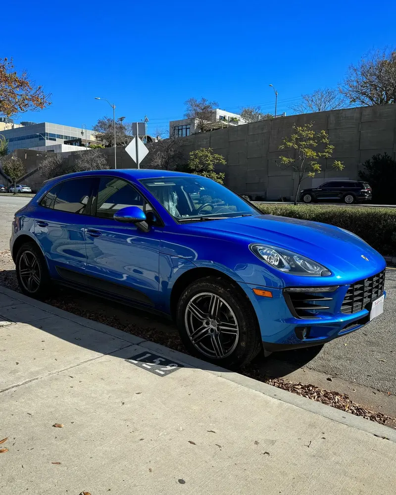Blue Porsche Macan parked on the street