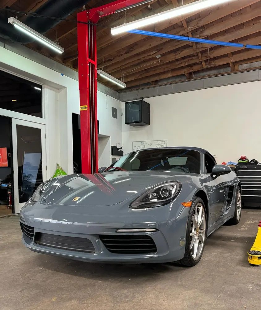 Grey Porsche 718 Boxster inside the shop