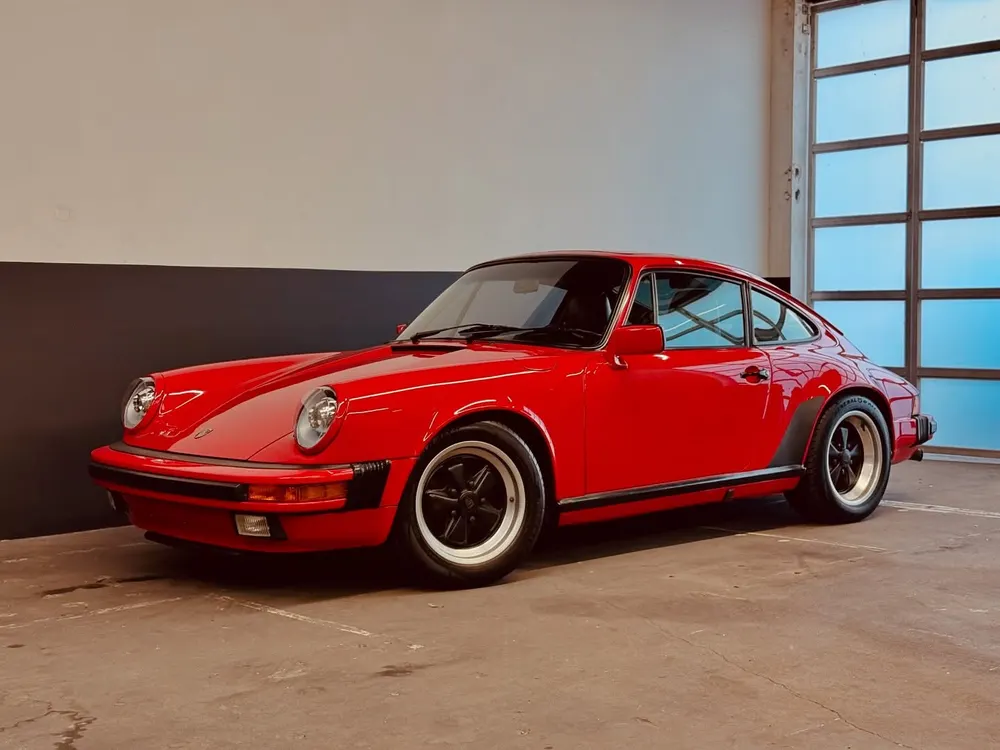 Red air-cooled Porsche 911 coupe inside the shop
